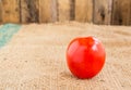 Close up Fresh red tomato on grunged sack background