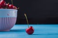 Close-up fresh ripe cherry on blue wooden desk. Royalty Free Stock Photo