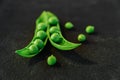 Close up of fresh ripe green peas on black background. Healthy organic food Royalty Free Stock Photo