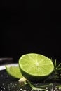 Close-up of fresh, ripe, juicy half of a green lime on a black background. Citrus fruit full of vitamins. Copy space. Royalty Free Stock Photo