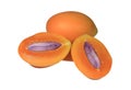 Close-up of fresh ripe Marian Plums orange color whole fruit and cut in half with purple seed