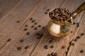 Close up of fresh roasted coffe beans in  cezve traditional turkish coffee pot on wooden table Royalty Free Stock Photo