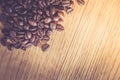Close up of fresh roasted coffee beans on wooden background Royalty Free Stock Photo