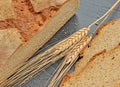 Close-up of fresh rustic bread with ears of wheat. Royalty Free Stock Photo