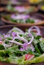 Close up of fresh salad bowl with lettuce, red onion, radish and borage flowers Royalty Free Stock Photo