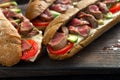 Close up fresh sandwich with beef grilled, tomato and avocado Royalty Free Stock Photo