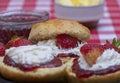 Close up of fresh scones topped with strawberry jam,cream Royalty Free Stock Photo