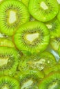 Close-up fresh slices of juicy kiwi fruit on white background. Slices of kiwi fruit in sparkling water on white Royalty Free Stock Photo