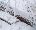 Close up of fresh snow coating and layering on garden wire fence