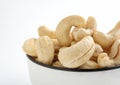 Close up of Fresh tasty cashew nuts in bowl on white background. Top view Royalty Free Stock Photo