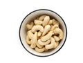 Close up of Fresh tasty cashew nuts in bowl on white background. Top view. Royalty Free Stock Photo