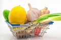 Close-up Fresh vegetables in a cart from a supermarket on a white background, natural fresh products, head of garlic, ginger Royalty Free Stock Photo