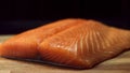 Close up for fresh, yummy salmon steak on wooden cutting board, isolated on black background. Raw red fish fillet on Royalty Free Stock Photo
