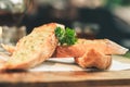 Close up Freshly baked garlic bread on wood plate. Royalty Free Stock Photo