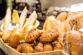 Close up freshly baked pastry goods on display in bakery shop. grocery market. Fresh bread, buns and rolls in wicker basket. Selec Royalty Free Stock Photo