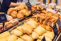 Close up freshly baked pastry goods on display in bakery shop. Selective focus Royalty Free Stock Photo