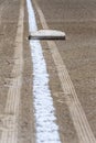 Close up of freshly chalked baseline, with base plate, dirt only, empty baseball field on a sunny day Royalty Free Stock Photo