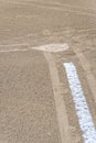 Close up of freshly chalked baseline leading to home plate, dirt only, empty baseball field on a sunny day