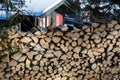 Close up of freshly chopped wood pile with a cabin in the background Royalty Free Stock Photo