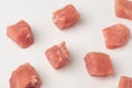 Close-up on freshly cut pork cubes on white background