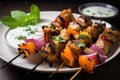 close-up of freshly grilled yogurt marinated kebabs on a plate