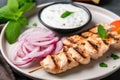 close-up of freshly grilled yogurt marinated kebabs on a plate