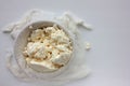 Close-up of freshly made white soft cottage cheese in bowl on white table background. Homemade ricotta in cheesecloth. Royalty Free Stock Photo