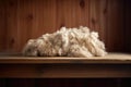 close-up of freshly sheared wool on a wooden table