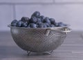 Close-up of freshly washed blueberries in a stainless steel colander