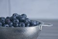 Close-up of freshly washed blueberries in a stainless steel colander