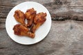 Close up a fried chicken wings in white dish on a wooden background Royalty Free Stock Photo