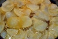 A close up of fried chips potatoes frying in boiling hot oil in a deep fryer at home. fast fries, Junk food concept Royalty Free Stock Photo