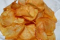 A close up of fried chips potatoes served in a plate covered with kitchen towels. fast fries, Junk food concept, home made Royalty Free Stock Photo