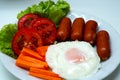 Close-up Fried egg with sausages and vegetables Royalty Free Stock Photo