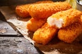 Close-up of fried fish fingers served on paper