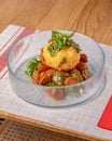 Close-up of fried mozzarella and cherry tomatoes arranged tastefully on a glass plate