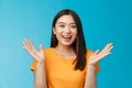 Close-up friendly happy cute asian female student clap hands joyfully, smiling broadly looking funny amusing performance