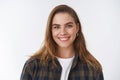 Close-up friendly-looking happy positive lucky young female wearing checked shirt over t-shirt smiling broadly delighted