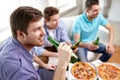Close up of friends with beer and pizza at home Royalty Free Stock Photo