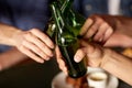 Close up of friends drinking beer at bar or pub