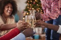 Close Up Of Friends Making A Toast With Champagne As They Celebrate Christmas At Home Together Royalty Free Stock Photo