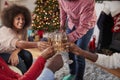 Close Up Of Friends Making A Toast With Champagne As They Celebrate Christmas At Home Together Royalty Free Stock Photo