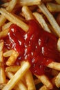 Close-up of fries with ketchup topping.
