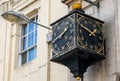 Close up of Frome Selwood clock with 2 clock faces showing at the bottom of Stony Street and Catherine Hill in Frome, Somerset, U