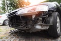 Close-up of front black car damaged and broken by accident Royalty Free Stock Photo