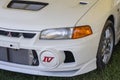 White mitsubishi lancer evolution iv front bumper and headlight showing iv badge Royalty Free Stock Photo