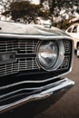 Close-up of the front end of a classic car, highlighting the chrome metal grille, the front emblem Royalty Free Stock Photo