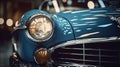 A close-up of the front headlight. Front view of a blue luxury retro car. Old School blue car headlight