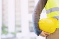 Close up front view of engineering male construction worker stand holding safety Royalty Free Stock Photo