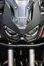 Close-up front view of Honda Africa Twin. Beautiful motorcycle of Japanese brand in black. Close-up of Headlights, predatory sight Royalty Free Stock Photo